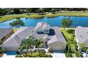 Scenic aerial view of the home near a tranquil lake and a lush golf course in the neighborhood at 2246 Sifield Greens Way # 36, Sun City Center, FL 33573
