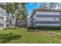 Beautiful condo building with multiple units and lush green lawn and landscaping at 2650 Countryside Blvd # A104, Clearwater, FL 33761