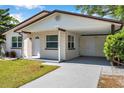 This lovely home features a convenient carport and well-maintained landscaping, offering curb appeal at 2873 Karen Ave, Largo, FL 33774