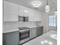 Modern kitchen features sleek cabinetry, stainless steel appliances, and a stylish quartz countertop at 2873 Karen Ave, Largo, FL 33774