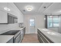 Bright kitchen showcasing stainless appliances, a center island, and modern pendant lighting at 2873 Karen Ave, Largo, FL 33774