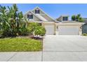 Charming home featuring a lush landscaped yard and a two-car garage at 2919 Northfield Dr, Tarpon Springs, FL 34688