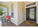 Welcoming front porch features a cozy bench, decorative details, and double doors to the home at 2919 Northfield Dr, Tarpon Springs, FL 34688