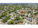 An aerial view showing the property's location within a neighborhood near a lake and highway, marked with a red arrow at 3647 Scarlet Tanager Dr, Palm Harbor, FL 34683