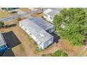 Aerial view of a well-maintained single-story home with a metal roof at 37229 Cora Ave, Zephyrhills, FL 33542