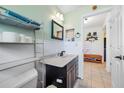Neat bathroom with a dark vanity, white countertops, and shelving for storage at 4124 Pine Dale Ct, Hernando Beach, FL 34607
