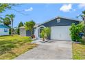Inviting single-story home with a well-kept lawn, mature landscaping, and a cozy, screened entryway at 4124 Pine Dale Ct, Hernando Beach, FL 34607