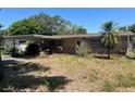 Traditional single-story home with a carport and brick veneer accents on a sunny day at 4191 71St N Ave, Pinellas Park, FL 33781