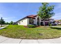 Beautiful home with a well-manicured lawn and a charming, landscaped yard at 4975 Night Star Trl, Odessa, FL 33556