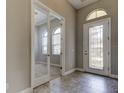 Inviting foyer with tile floors, glass door entry, and bright windows that welcome natural light at 4975 Night Star Trl, Odessa, FL 33556