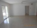 Bright living room with terrazzo floors, sliding glass doors, and neutral walls, offering a versatile living space at 5318 7Th N Ave, St Petersburg, FL 33710
