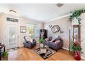 Inviting living room boasts wood floors, comfortable seating, and a bright window at 708 Sandy Hills Ave, Tarpon Springs, FL 34689