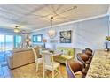 Bright, open-concept living space with tile floors, coastal decor, and balcony access at 7480 Bayshore Dr # 402, Treasure Island, FL 33706