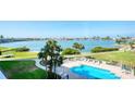 Inviting outdoor swimming pool surrounded by lush landscaping and serene water views, perfect for relaxation at 7872 Sailboat Key S Blvd # 306, South Pasadena, FL 33707