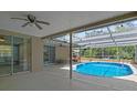 Inviting backyard pool area with a screened enclosure and ample patio space at 8317 Needles Dr, Hudson, FL 34667