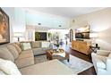 Bright living room with an open floor plan, a sectional sofa, and hardwood floors at 9072 Baywood Park Dr, Seminole, FL 33777