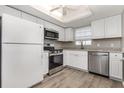 Updated kitchen features stainless steel appliances, white cabinets, and granite countertops at 942 Capri Isles Blvd # 207, Venice, FL 34292