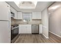 Bright kitchen with stainless steel appliances, white cabinets, and skylight at 942 Capri Isles Blvd # 207, Venice, FL 34292