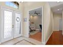 Welcoming foyer with tiled floors, a glass-paneled door, and an adjacent office space at 10141 Deercliff Dr, Tampa, FL 33647