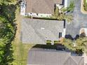 Aerial view of the home's roof showing the gutters, yard, and the screened in porch in the back yard at 10503 Dotham Ct, Tampa, FL 33626