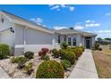 Beautiful single Gathering home with manicured landscaping and walkway leading to the front door at 1112 Jasmine Creek Ct, Sun City Center, FL 33573