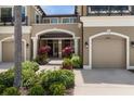 Charming entrance with a covered porch and a well-maintained front garden with colorful plants at 11442 Crowned Sparrow Ln, Tampa, FL 33626