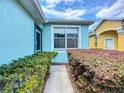 A well-maintained blue home with charming landscaping and a stone pathway leading to the front entrance at 11457 Captiva Kay Dr, Riverview, FL 33569