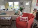 Cozy living room with hardwood floors and natural light, complete with comfy seating at 1165 Falcon Dr, Dunedin, FL 34698