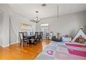 Bright and airy dining room featuring a stylish chandelier, a play area, and hardwood floors at 11808 Lancashire Dr, Tampa, FL 33626