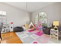 Spacious playroom area bathed in natural light with toys, play equipment, and hardwood floors at 11808 Lancashire Dr, Tampa, FL 33626
