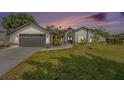 Charming single-story home featuring a well-manicured lawn and a two-car garage at 12317 Smokey Dr, Hudson, FL 34669