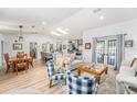 Bright open-concept living space with hardwood floors, a dining area, and a modern kitchen at 12317 Smokey Dr, Hudson, FL 34669