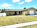 Charming single-story home with a well-maintained lawn and an attached one-car garage at 13924 Pathfinder Dr, Tampa, FL 33625