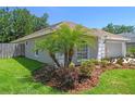 Attractive home showcasing lush landscaping including palm trees, complemented by a well-maintained lawn at 1517 Little Brook Ln, Brandon, FL 33511