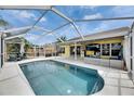 A beautiful screened-in pool with ample patio space, seating, and a TV, perfect for outdoor entertaining at 221 Lakeway Ln, Apollo Beach, FL 33572