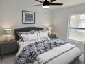 Inviting bedroom with a plush bed, elegant bedside tables, and a bright window at 2528 Columbus S Way, St Petersburg, FL 33712
