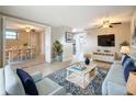 Bright and airy living room featuring stylish decor, tile floors, and a dining area at 2600 N Paula Dr # 2B, Dunedin, FL 34698