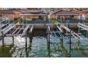 Elevated shot of the property's waterfront access, showcasing private boat slips on a sunny day at 2600 N Paula Dr # 2B, Dunedin, FL 34698