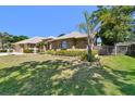 Beautiful home with mature landscaping, including palm trees, and a charming front water fountain at 2914 Timber Knoll Dr, Valrico, FL 33596