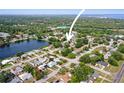 Expansive aerial view of a neighborhood with a lake and lush green surroundings, offering a serene environment at 2964 Catherine Dr, Clearwater, FL 33759
