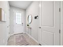 Bright entryway featuring neutral walls, tile flooring, and stylish decor at 31779 Asbury Ave, Wesley Chapel, FL 33545