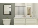 Bright bathroom features a white vanity with marble countertop, framed art, and classic subway tile at 32122 Griffin Sands Ln, San Antonio, FL 33576