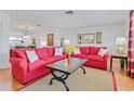 Bright living room with hardwood floors, comfortable seating, and stylish decor at 3408 90Th N Ter, Pinellas Park, FL 33782