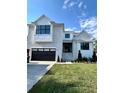 Beautiful two-story home with black trim, a brick driveway, and a well-manicured lawn at 4607 W Lamb Ave, Tampa, FL 33629