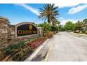 Attractive stone sign marking the entrance to Country Walk, surrounded by colorful flowers and lush landscaping at 4725 Royal Birkdale Way, Wesley Chapel, FL 33543