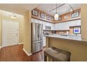 Modern kitchen featuring stainless steel appliances, white cabinets, and a breakfast bar with seating at 504 S Armenia Ave # 1338, Tampa, FL 33609