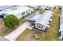 Birds-eye view of the home with metal roof, covered parking, and compact yard space at 5428 Joyce St, Zephyrhills, FL 33542