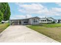 Charming single-story home featuring covered parking and tidy landscaping in a community setting at 5428 Joyce St, Zephyrhills, FL 33542