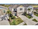 An aerial view of a modern two-story home with a well-kept lawn and convenient two-car garage at 5486 Summer Sunset Dr, Apollo Beach, FL 33572