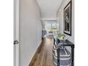 Inviting hallway with stylish decor, wood floors, and a view into a naturally lit living room at 5486 Summer Sunset Dr, Apollo Beach, FL 33572